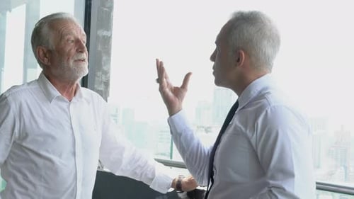 Two senior businessman discussion with partnership about work at office.