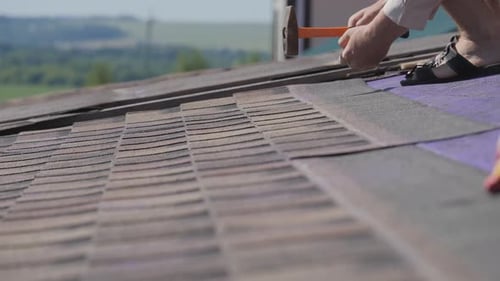 Roofing Work. Laying a Soft Roof on the Roof of a Private House.