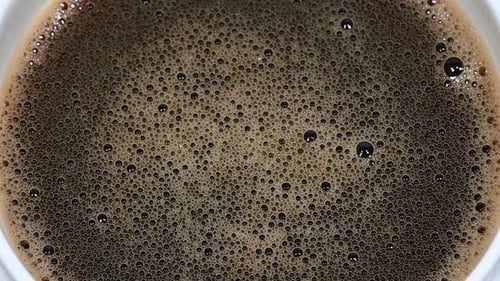 Soluble coffee froth rotating in cup