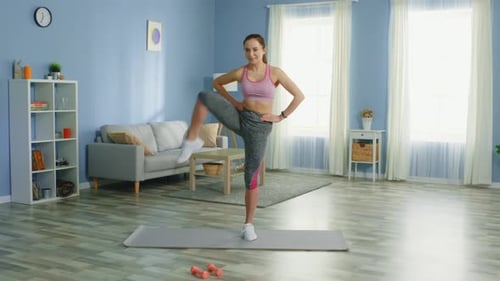 Woman Doing Leg Lifts on Exercise Mat