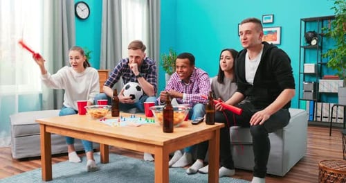 Friends Watch Tense Sports Game on Television