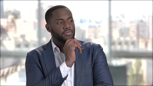 Contemplative Man in Suit Thinks in Office