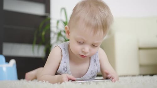 Young Child Engaged with a Mobile Phone at Home