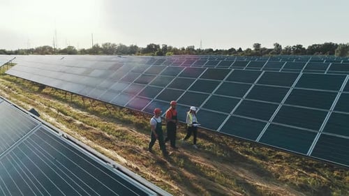 Top View of Specialists Walking Across a Solar Power Plant