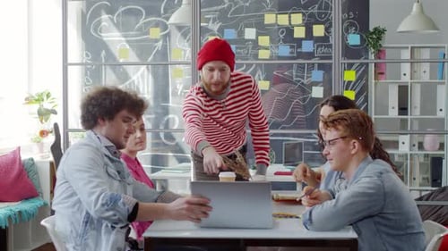 Team Discussing Strategy in Modern Open Office