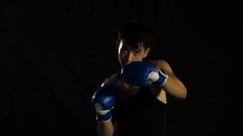 Young Boxer Throwing Punches in Front of Camera