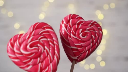 Heart Shaped Lollipops Rotating in Front of Bokeh Lights
