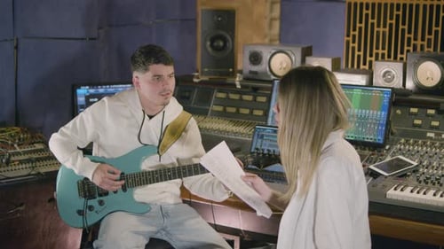 Two Musicians Working in Music Studio While Recording New Song