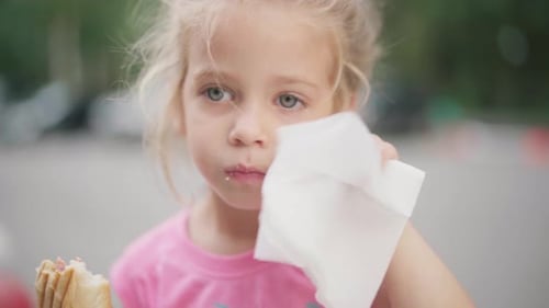 Little Girl Eat Hot Dog Summer Park Food And Drink Concept