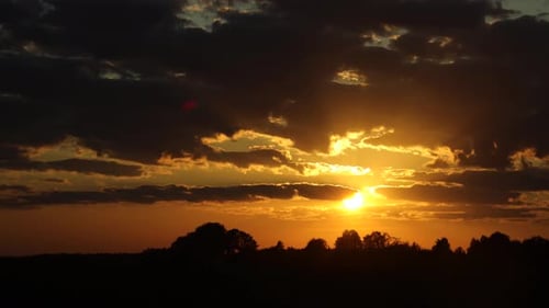 Dramatic Clouds and Golden Sunset over Horizon