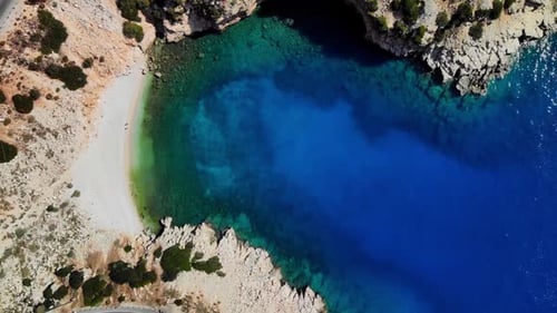 Top Down Aerial View of Beautiful Blue Bay Among Serpentine Mountain Road