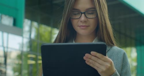 Gros plan d'une femme tient une tablette numérique moderne. Femme d'affaires tapant sur sa tablette numérique