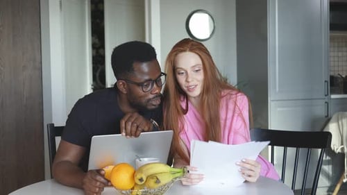 Married Couple Checking Documents at Home