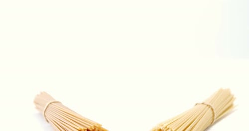 Two Bundles of Spaghetti Ready for Cooking