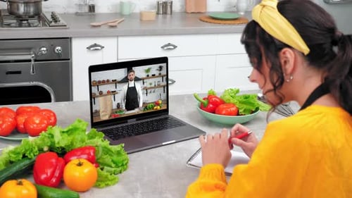 Woman Taking Online Cooking Class at Home