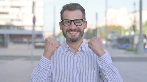 Man Expressing Joy in City Street