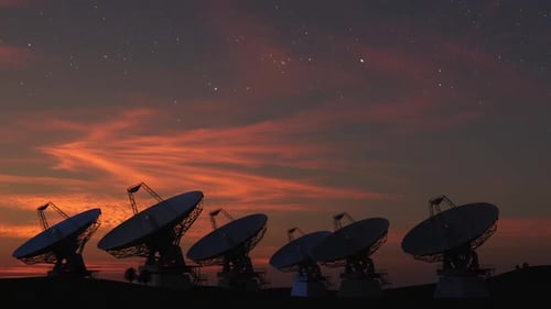 Satellite Dishes Rotating Under Starry Twilight Sky
