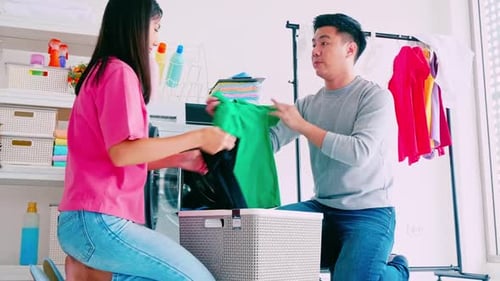 Young Couple Doing Laundry Together at Home