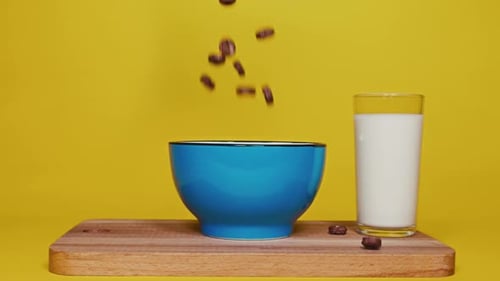 Breakfast Cereal Falling into Bowl with Milk