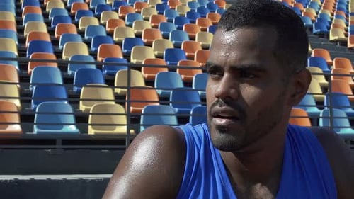 Sweaty Athlete Resting Restoring Strength and Breathing After Grueling Workout