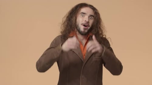 Man With Long Hair Gives Thumbs Up Gesture