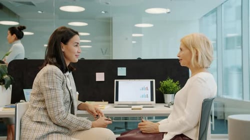Slow Motion of Business Women Young and Mature Talking at Desk in Office