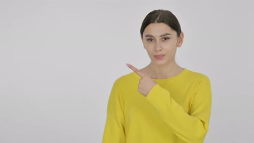 Woman in Yellow Sweater Points to the Left