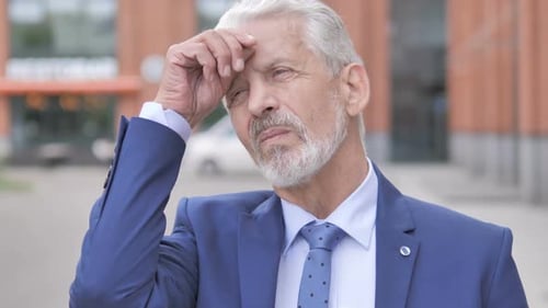 Senior Man Searching and Shielding Eyes