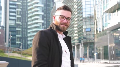 Stylish Man Smiling in Modern Urban Environment