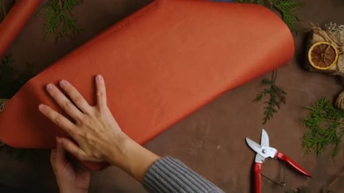 Wrapping Christmas Gift with Craft Paper and Pine