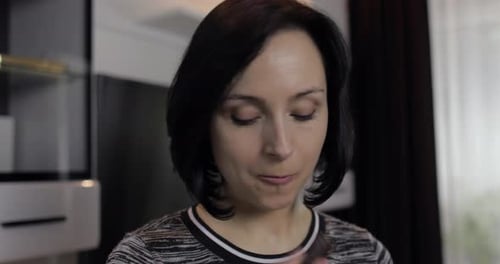 Woman Enjoys Chocolate and a Drink at Home