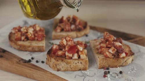 Chef Preparation Italian Food Garnishing Bruschetta with Roasted Tomatoes Basil and Cheese Cooking