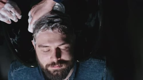 Bearded Man Getting Hair Washed at Salon