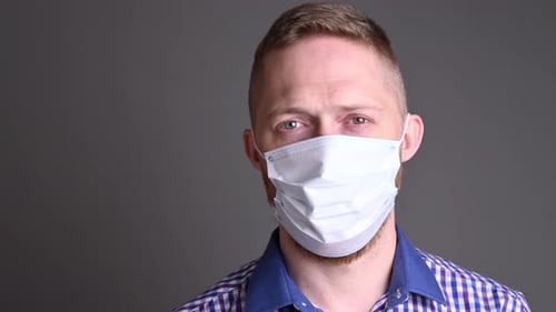 Man Takes Off Protective Medical Face Mask