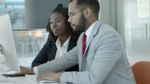 Business Professionals Working Together on Computer in Office