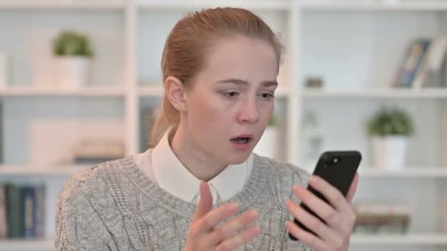 Shocked Woman Reacting to Content on Mobile Phone