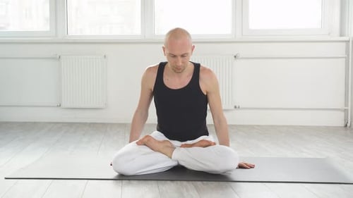 Man Meditating, Sitting on Yoga Mat