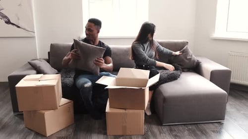 Couple Unpacking Boxes at Their New Home