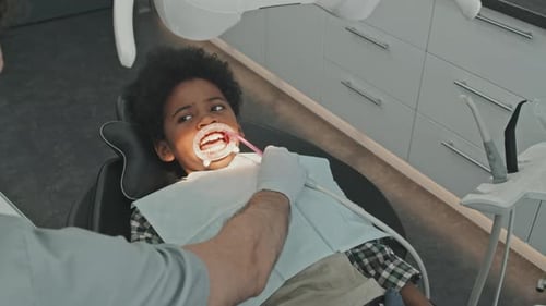 Child Receives Dental Exam in Modern Office