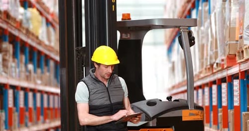 Male warehouse worker using digital tablet