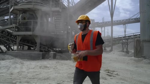 Male Quarry Worker Removing Protective Gear