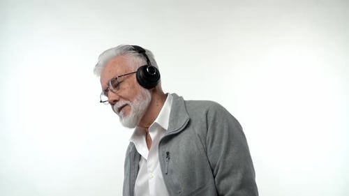 Senior Man Listening to Music with Headphones