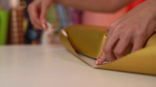 Wrapping a Birthday Gift with Gold Paper