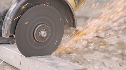 Sparks From Cutoff Disc Cutting Aluminum Tubular At Workshop. close up