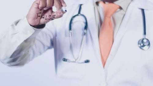 Doctor Writing False Statement on Transparent Surface