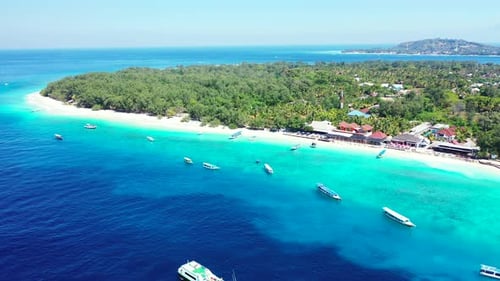 Beautiful tropical island with trees forest, white sandy beach surrounded by calm clear water of blu
