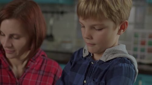 Mother and Son Sorting Recyclables at Home