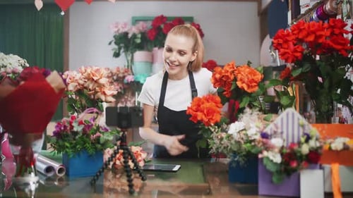 Woman Vlogging in Flower Shop Surrounded by Blooms