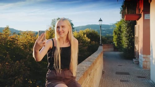 Woman Taking a Selfie in the Daytime Sun