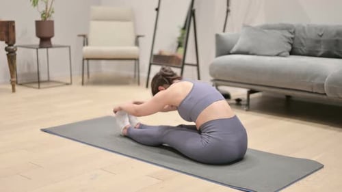 Woman Stretching in Home Living Room